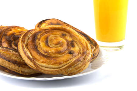Hot bun with raisin and orange juice isolated on a white backgroundの写真素材