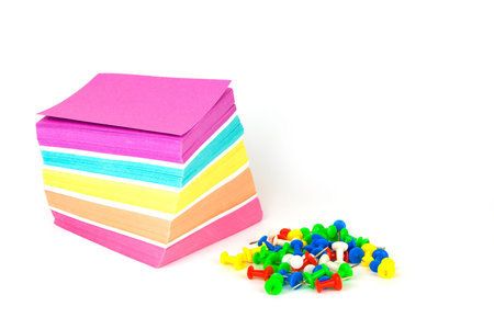 Colorful note paper and pins isolated on a white background