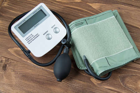 Electronic tonometer on a wooden background. Close upの写真素材