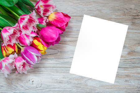 Beautiful floral background. Bouquet of tulips on a wooden background.の写真素材