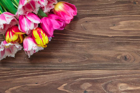 Bouquet of beautiful tulips on a brown wooden background. Top viewの写真素材