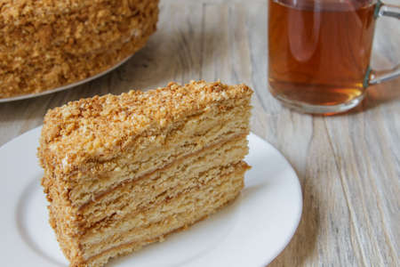 Piece of tasty cake Napoleon on wooden backgroundの写真素材