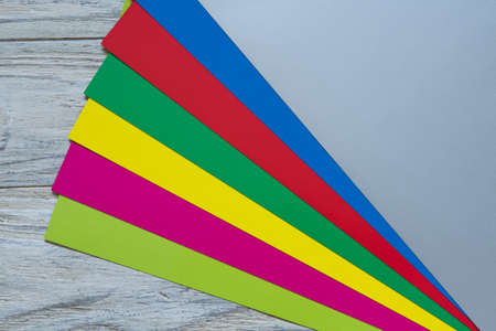 Color paper on wooden background diagonalの写真素材