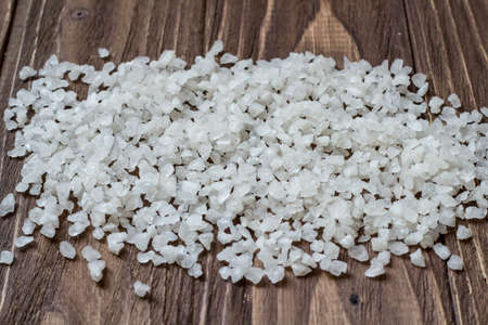 Wide pile of sea sault on wooden backgroundの写真素材