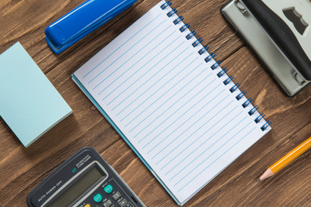 Office tools organized on wooden background