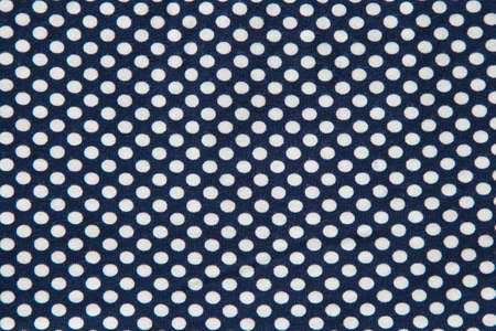 Textile white cirlces on dark backgroundの写真素材