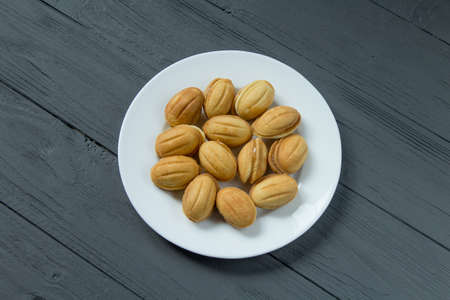 Homemade cookies with condenced milk on a white plateの写真素材