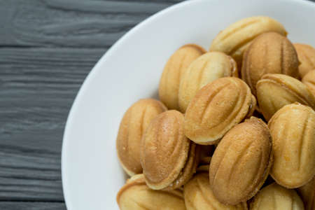 Pile of cookies with condenced boiled milk on white plateの写真素材