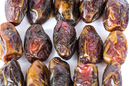 Dried dates in rows isolated on white