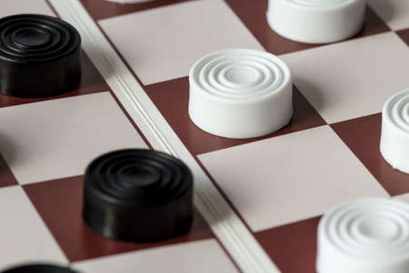 White and black checkers on gaming boardの写真素材