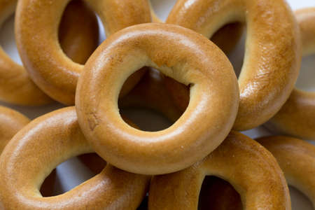 Heap of baked dry bagels close-up, top viewの写真素材