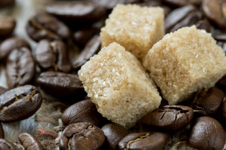Roasted coffee beans and sweet cane sugar close-upの写真素材