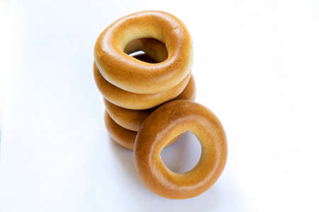 Pile of dry bagels isloated on white backgroundの写真素材