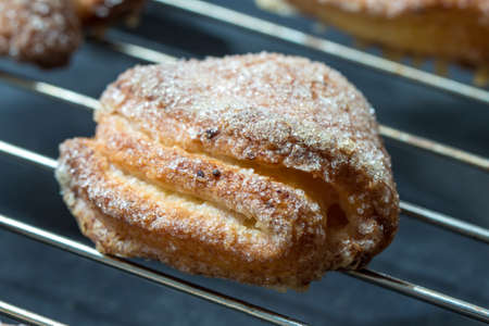 One puff pastry cookie on metal grid, close upの写真素材