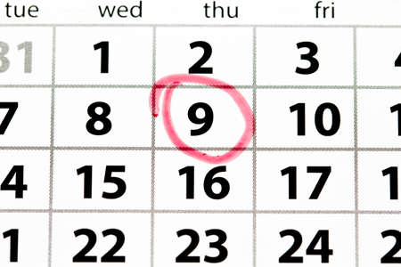 White calendar page with date circled in red, top viewの写真素材