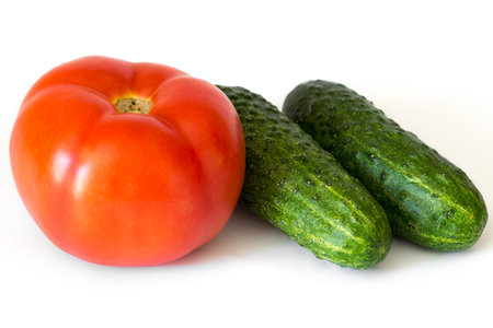 Tomato and cucumbers isolated on white background, close upの写真素材