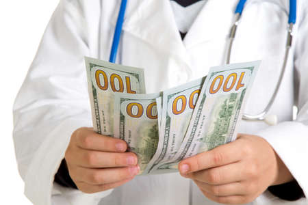 Dollars in the doctors hands. Counting moneyの写真素材