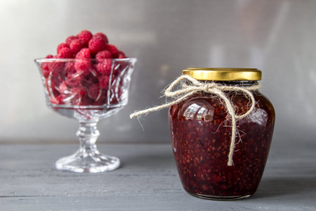 Jar of raspberry jam, healthy food. Front view jar of jam, second view fresh raspberry