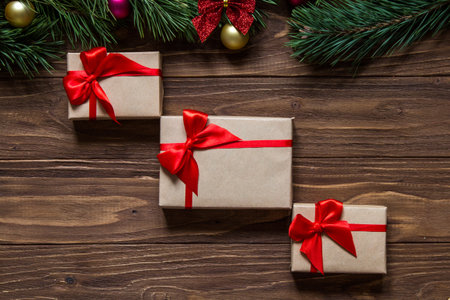 Nice christmas theme on the wooden background with pine tree branches on the top of the screen....
