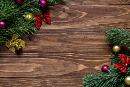 New Years Eve and Christmas theme with pine tree tinsel on the empty wooden background for your letteringの写真素材