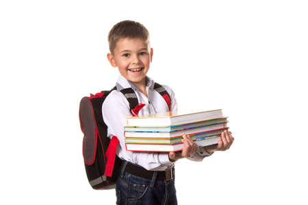 Smiling school boy with backpack holding notebooks, on white backgroundの写真素材