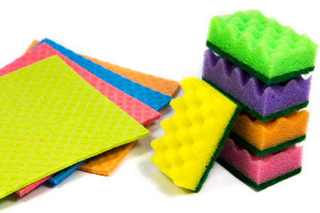 Cellulose sponge cloth and an organized stack of cleaning sponges, isolated on the white background,...