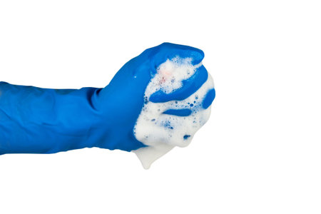 Sponge for washing dishes in hand, washing dishes isolated on a white background