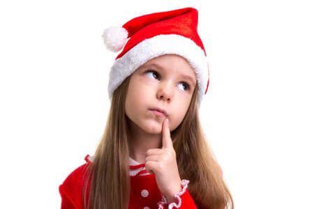 Closeup dreamy christmas girl wearing a santa hat isolated over a white backgroundの写真素材