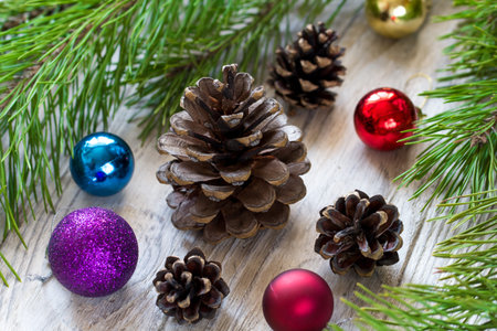 Christmas composition with fir tree branches, colorful balls and Christmas decorations on wooden...