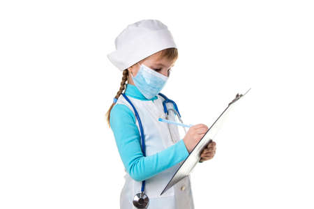 Female medical doctor or nurse with stethoscope and mask write a note in notebook against white background.の写真素材