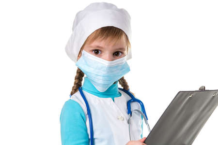 Close up of female medical nurse with stethoscope and mask write a note in notebook against white background, looking at the camera.の写真素材