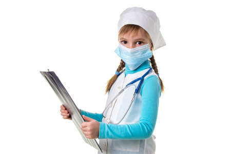 Landscape of female medical doctor or nurse with stethoscope and mask write a note in notebook against white background, looking straight to the cameraの写真素材