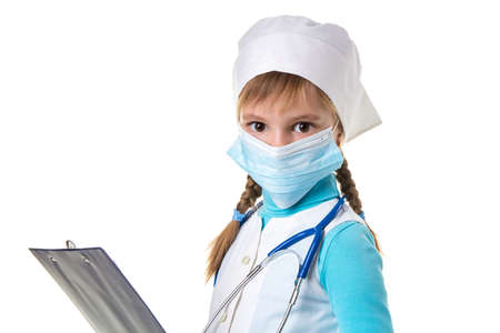 Close up landscape of female nurse with stethoscope, mask and notebook against white background, looking straight at the cameraの写真素材