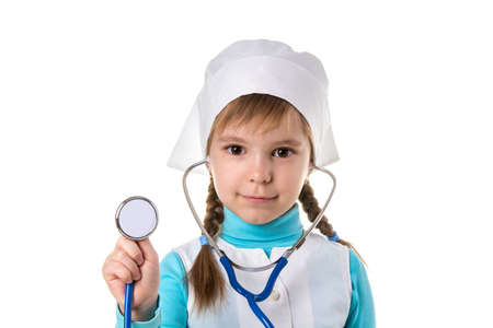 Girl nurse in white uniform with stethoscope in the ears. Holding stethoscope on the foreground. Landscapeの写真素材