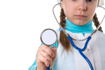 Stethoscope close-up. Nurse doctor girl in white dressing gown holds tool. Concept of medical care, insurance, store with medicine, white backgroundの写真素材