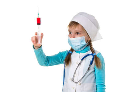 Nurse with medical face mask and a syringe with a drug, landscape white backgroundの写真素材