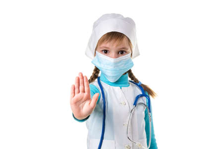 Female nurse doing stop sign with palm wearing medical mask. Warning expression with negative and serious gesture.の写真素材