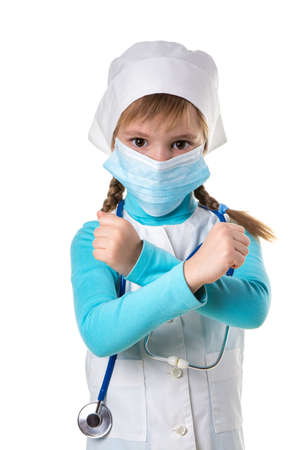 Female nurse showing cross sign wearing medical mask in white robe and stethoscope white backgroundの写真素材