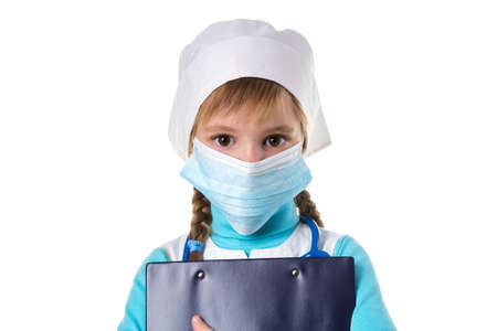 Female nurse wearing mask, holding a notebook looking straight at the camera, isolated on the white backgroundの写真素材