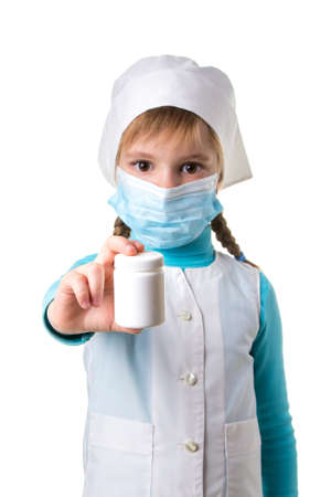 Female nurse pointing the white pill bottle isolated on white background, portrait orientationの写真素材