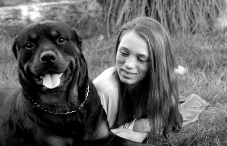 young woman and her best friends rottweiler dogの写真素材
