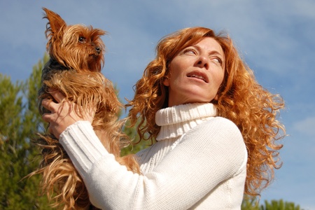 woman with red hair and her purebred yorkshire terrierの写真素材