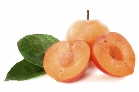 yellow plums in front of white backgroundの写真素材