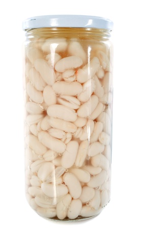 bottled preserves of white beans in front of white backgroundの写真素材