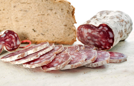 saucisson and bread in front of white background