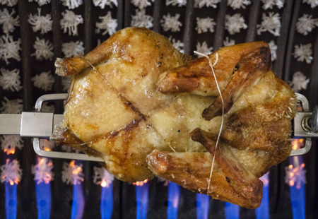 roast chicken in ceramic oven on a spitの写真素材