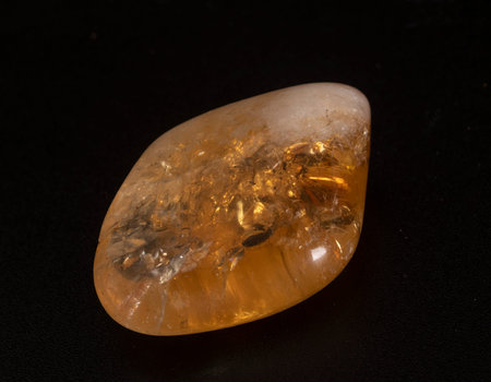 polished citrine in front of black  background