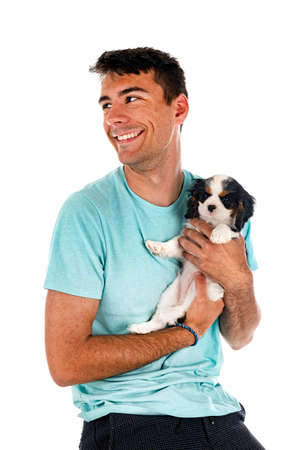 puppy cavalier king charles and man in front of white backgroundの写真素材