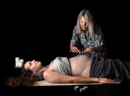 woman and energy healing in front of black backgroundの写真素材