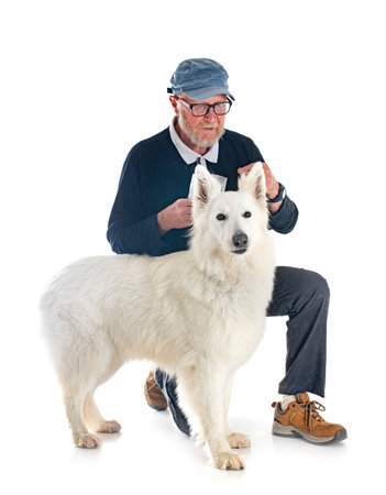 White Swiss Shepherd Dog and owner in front of white background